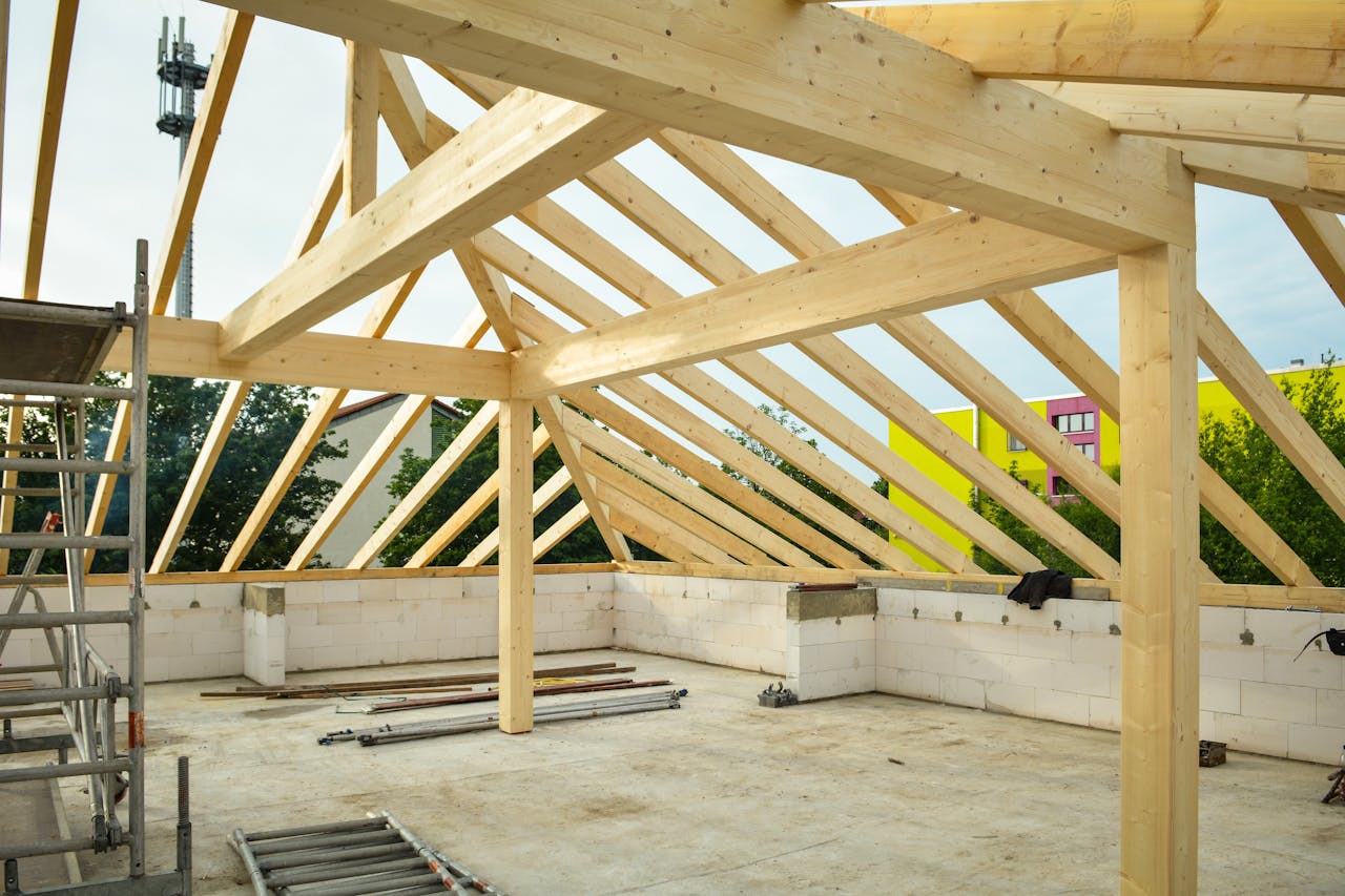 Entreprise Wooden roof structure in progress with open sky view, ideal for construction themes.
